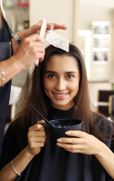 hairdresser-makes-hairstyle-to-female-customer-SAD5VL2.jpg